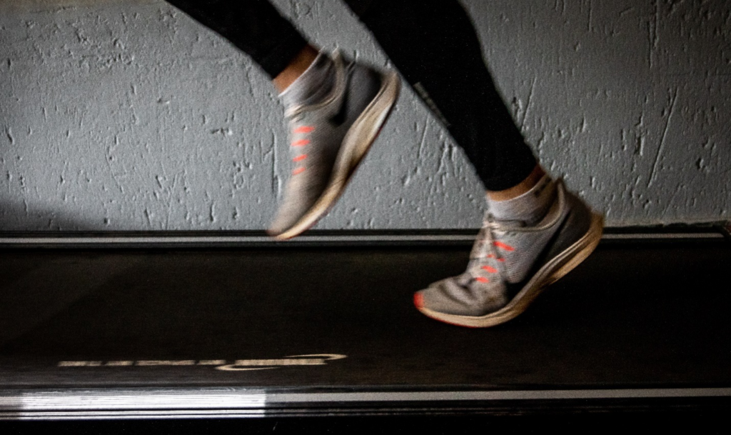 A pair of feet running on a treadmill