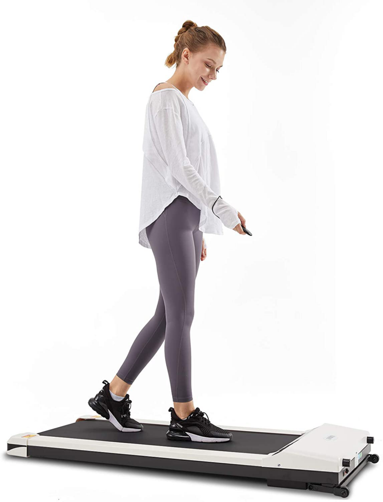 A woman walks on a treadmill