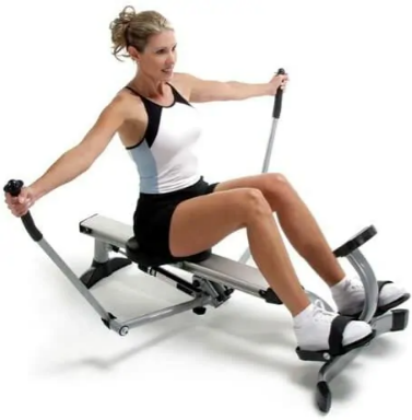 A woman in black and white exercise outfit uses a rowing machine